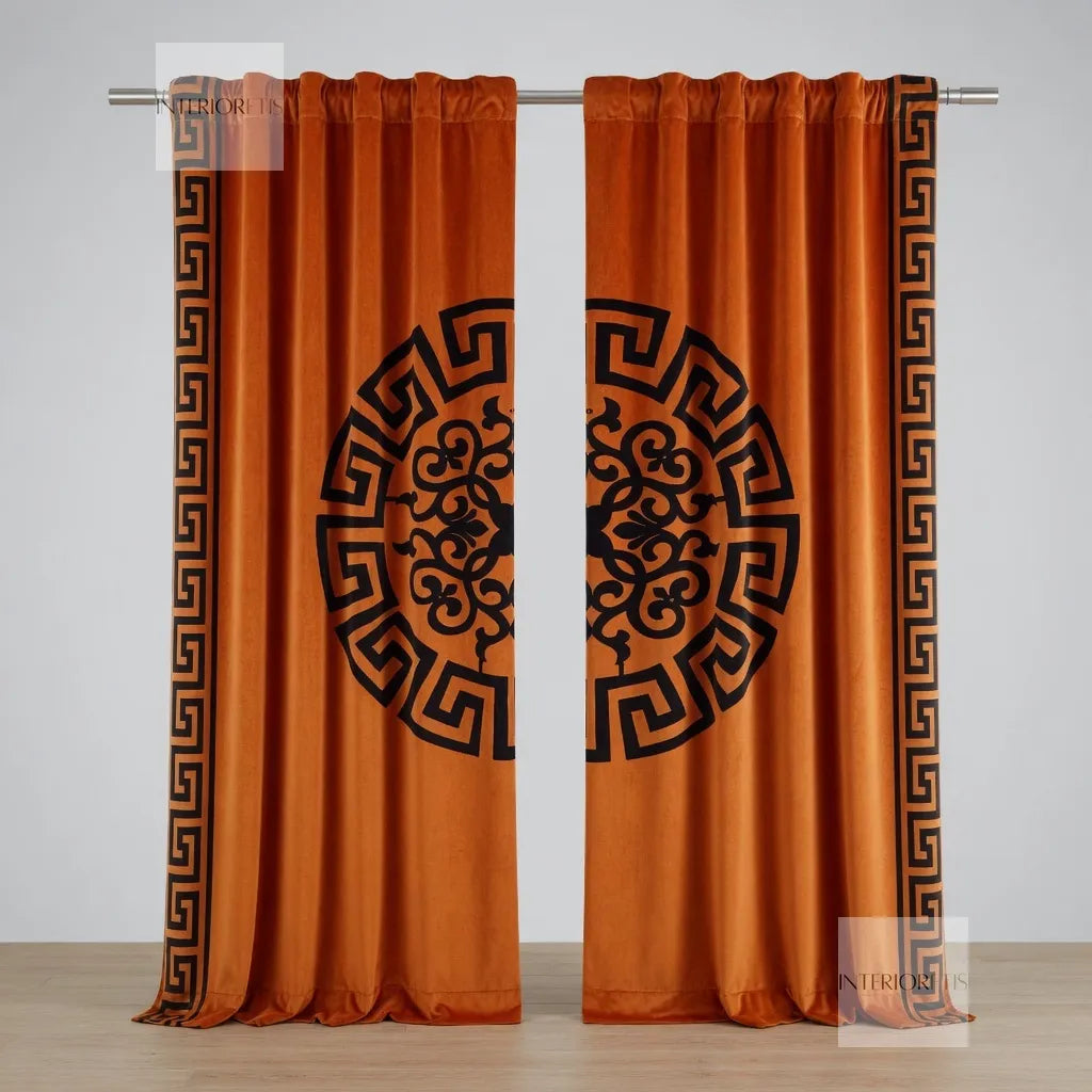 Pair of orange curtains with black decorative patterns on a white background