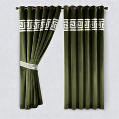 Green curtains with white geometric patterns on a plain background