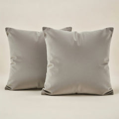 Two gray pillows on a light beige background